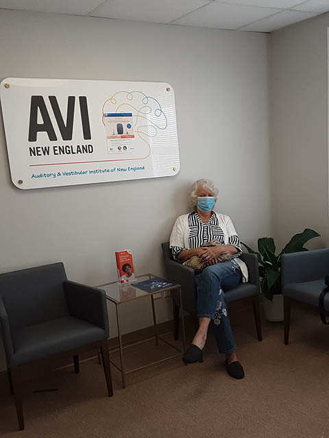 A senior hearing loss female patient in the waiting room at AVI New England